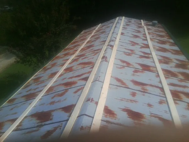 Rusted metal roof panels with new wood purlins before replacement — Storm Damage Roof Repair in Duanesburg by Roofing Brothers